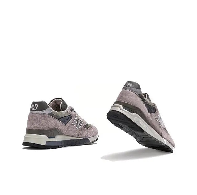 Grey low-top sneakers pair, N logo detail, lace-up design, layered sole units