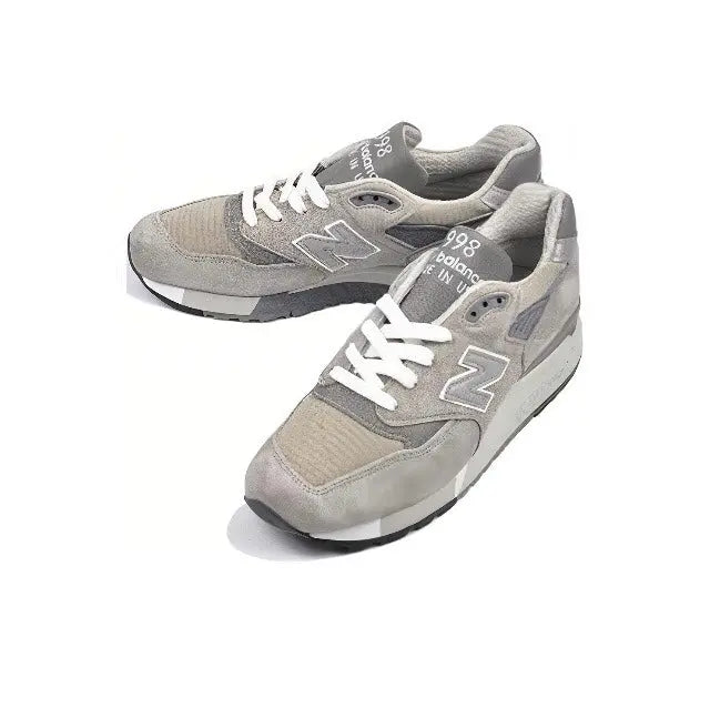 Grey low-top sneakers with N logo and white laces, padded tongue, treaded sole