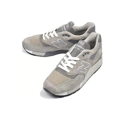 Grey low-top sneakers with N logo and white laces, padded tongue, treaded sole