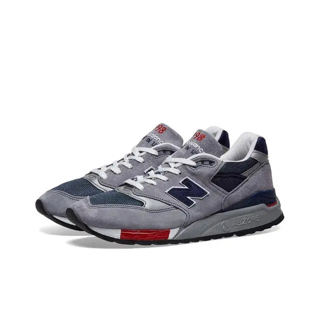 New Balance 998 grey lace-up sneaker with navy side logo and red trim