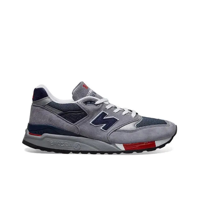 New Balance 998 grey running sneaker with navy heel and red sole stripe