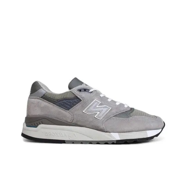 Grey low-top sneakers side view with N logo, white laces, cushioned midsole