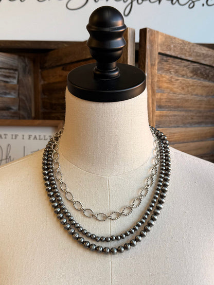 Triple-layer bead and chain necklace with dark beads and silver-tone center chain