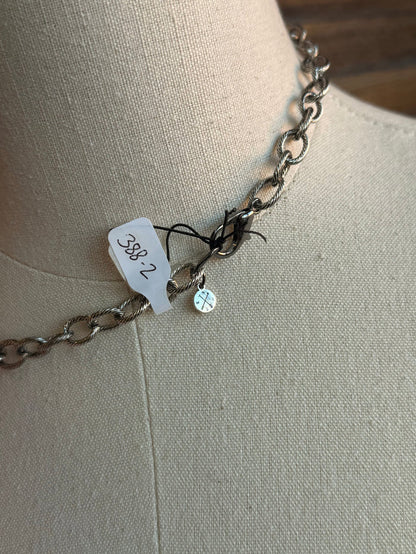Necklace chain end with small blue crystal charm and small engraved tag