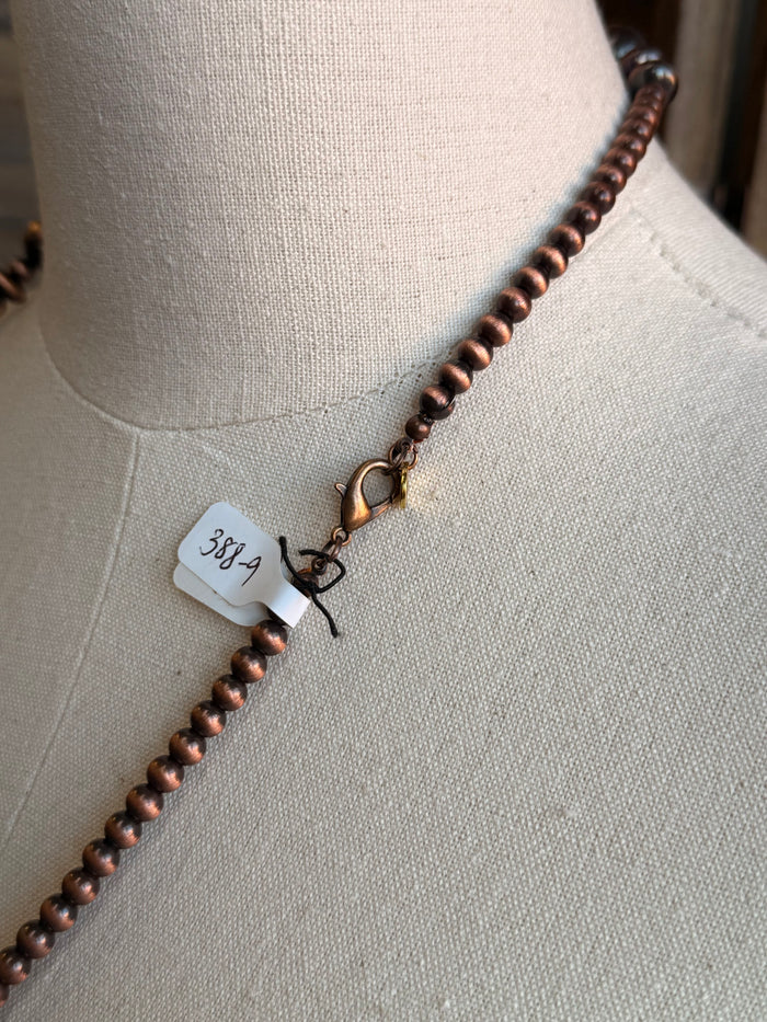 Copper bead necklace clasp with small tag and lobster hook detail
