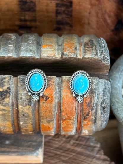 Silver oval turquoise stud earrings with bright oval cabochon and starburst drop detail