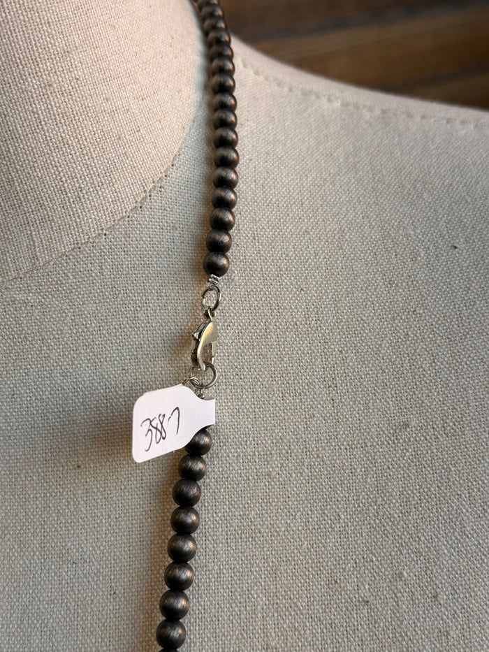Mixed silver pearl bead necklace clasp detail with small tag and round beads