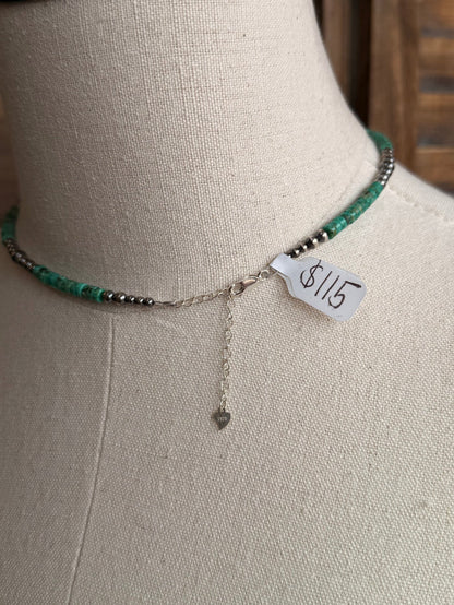 Sterling silver heishi necklace with green beads, 8/15 tag and dangling chain