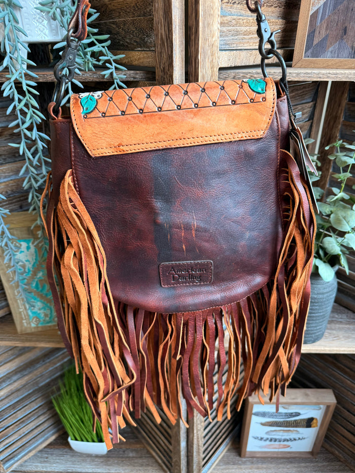 Brown leather fringed crossbody purse with embossed logo and top flap