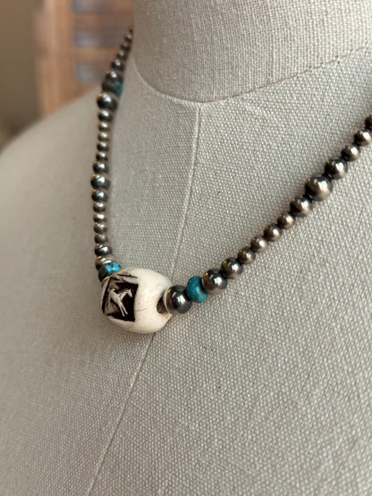 Running horse charm with turquoise bead accents on a silver bead necklace