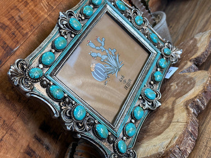Turquoise and silver decorative photo frame with close-up scrollwork border