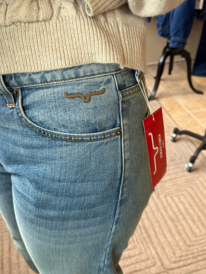 Mid-wash blue jeans with orange-stitched back pocket and small leather logo patch.