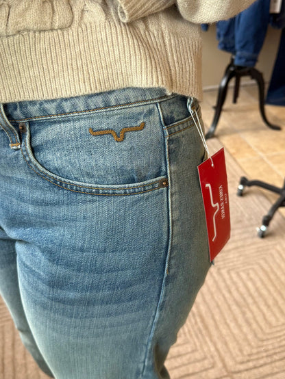 Mid-wash blue jeans with orange-stitched back pocket and small leather logo patch.