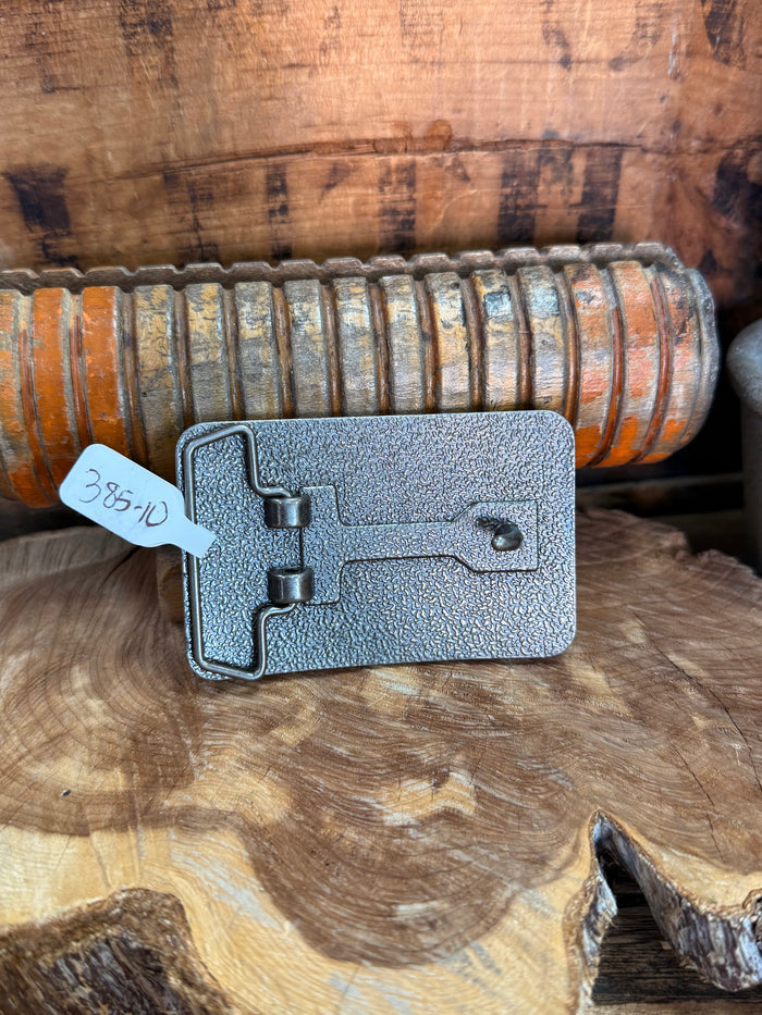 Cowboy belt buckle back side with silver clasp and hardware, rectangular metal plate