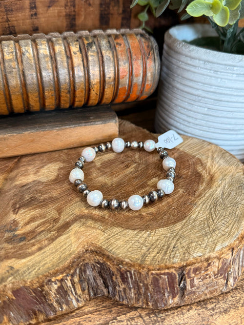 Stretchy freshwater pearl bracelet with iridescent white pearls and silver spacer beads