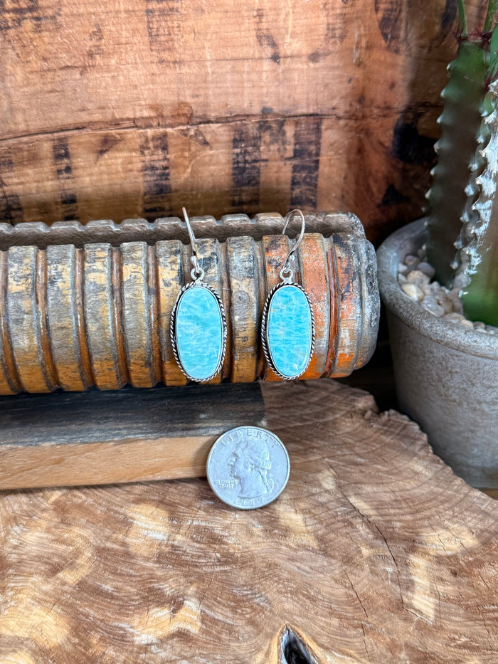 Silver fishhook earrings with oval blue stone cabochons, thin dangling hooks