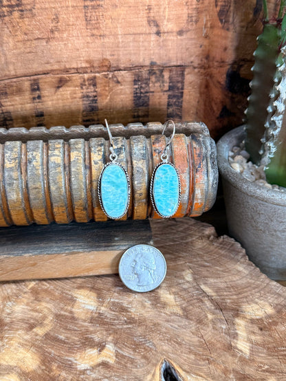 Silver fishhook earrings with oval blue stone cabochons, thin dangling hooks