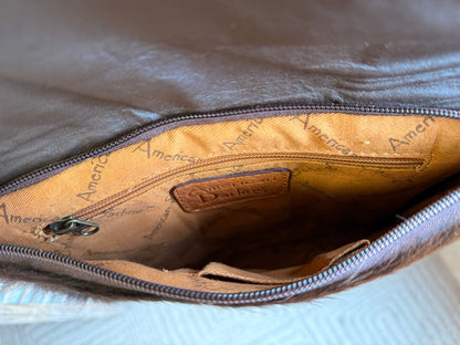 Crossbody purse interior with fabric lining and zippered top opening