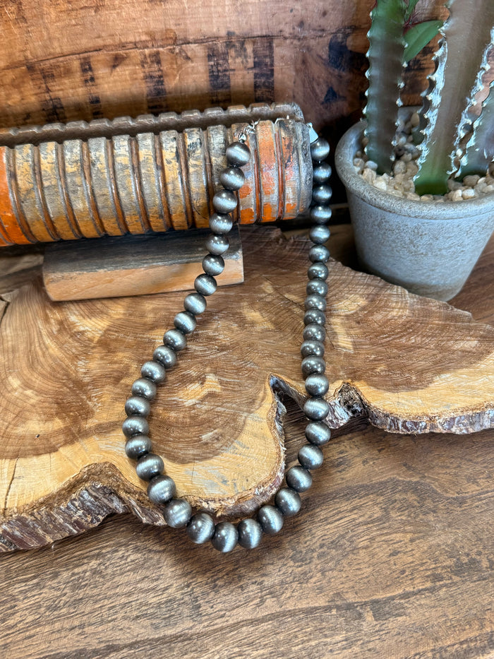 16-inch silver pearl bead necklace, U-shaped loop with evenly spaced round pearls.