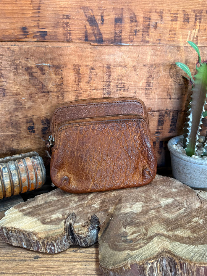 Brown cowhide double-zip coin wallet with textured finish and rounded front
