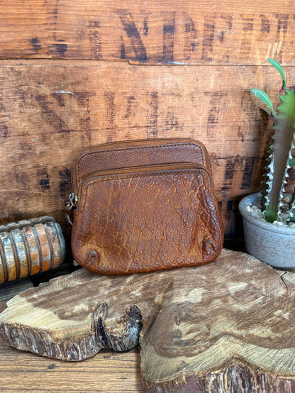 Brown cowhide double-zip coin wallet with textured finish and rounded front