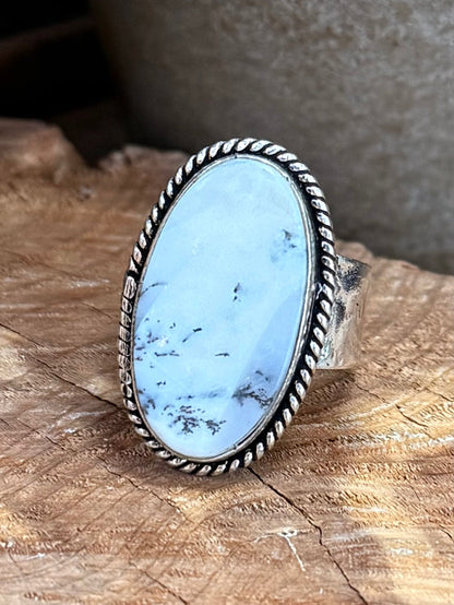 Oval light-blue opal ring with silver-tone bezel, rope-edged detail, adjustable fit