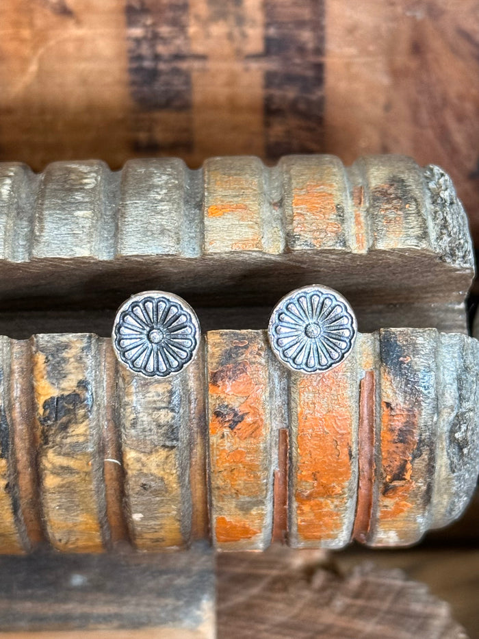 Pair of silver round concho stud earrings with etched flowerburst pattern