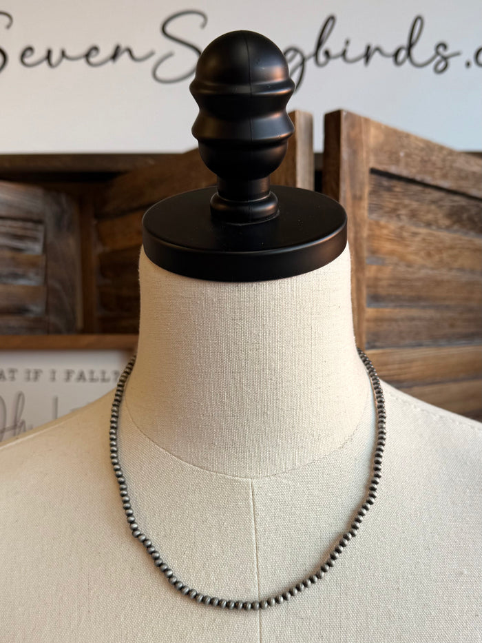 18in 4mm silver pearl necklace draped on mannequin bust, round clasp