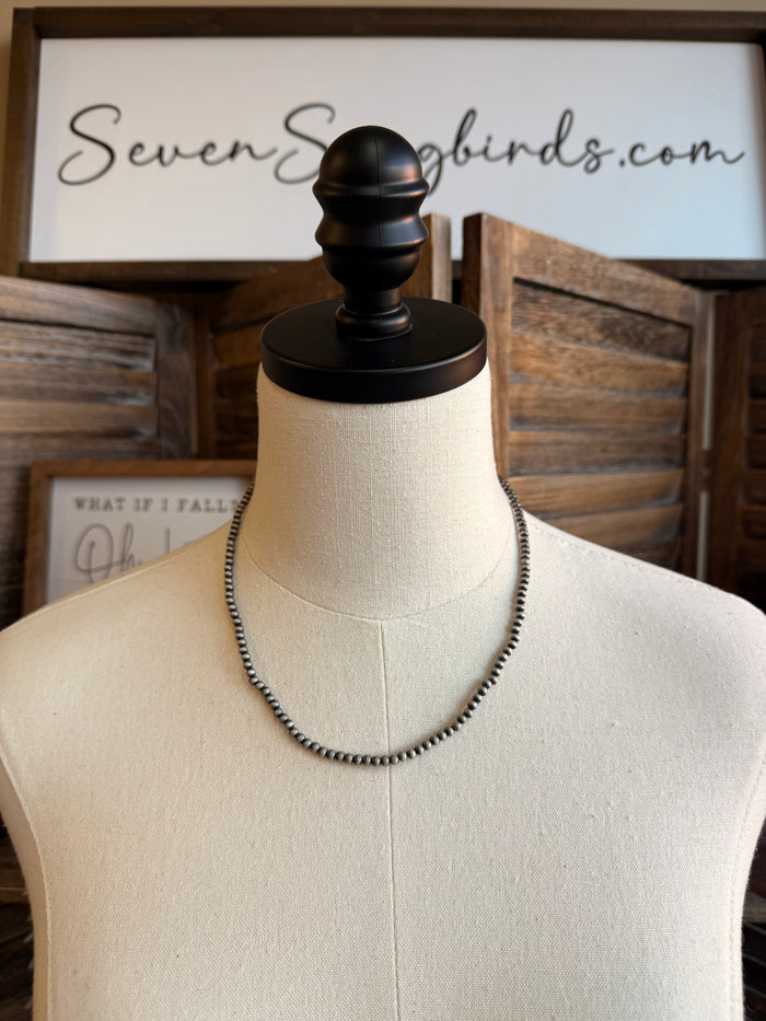 18in 4mm silver pearl necklace on mannequin, loop clasp