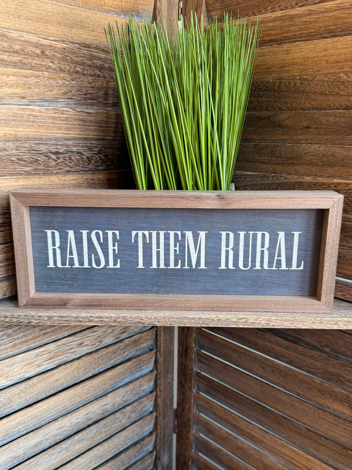 Framed 12x4 artwork with 'RAISE THEM RURAL' lettering on dark panel, light wood frame