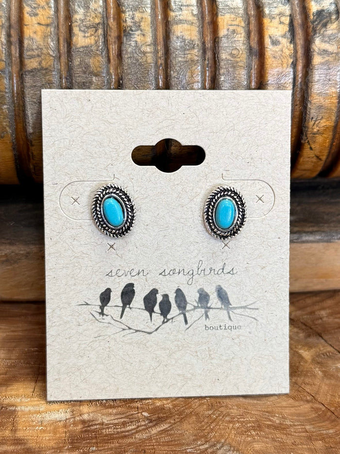 Round turquoise concho stud earrings with silver outer detailing and blue stone centers