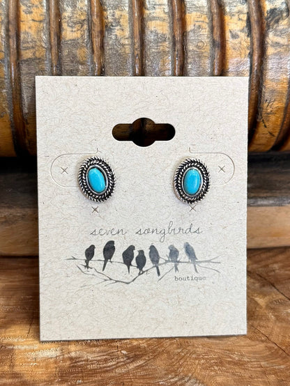 Round turquoise concho stud earrings with silver outer detailing and blue stone centers