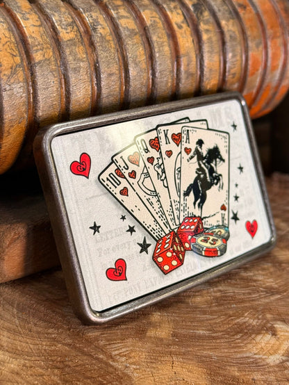 Rectangular cowboy royal flush belt buckle close-up, black cowboy on playing card fan