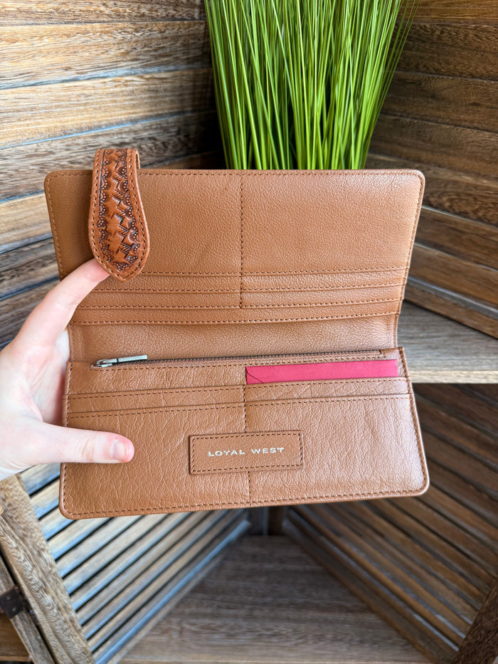 Tan leather wallet open with card slots, pink divider, and “LOYAL WEST” label