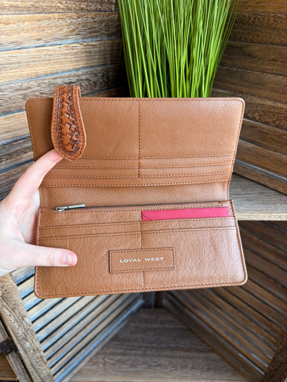Tan leather wallet open with card slots, pink divider, and “LOYAL WEST” label