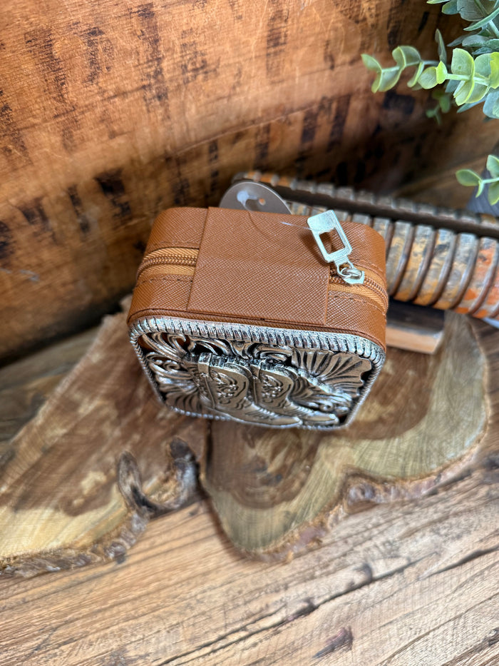 Brown leather travel jewelry box with engraved metal front panel and zipper