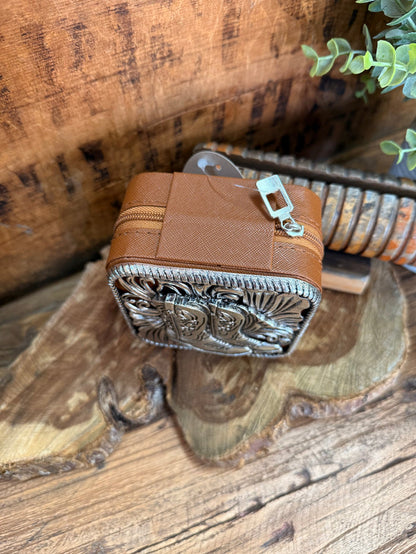 Brown leather travel jewelry box with engraved metal front panel and zipper