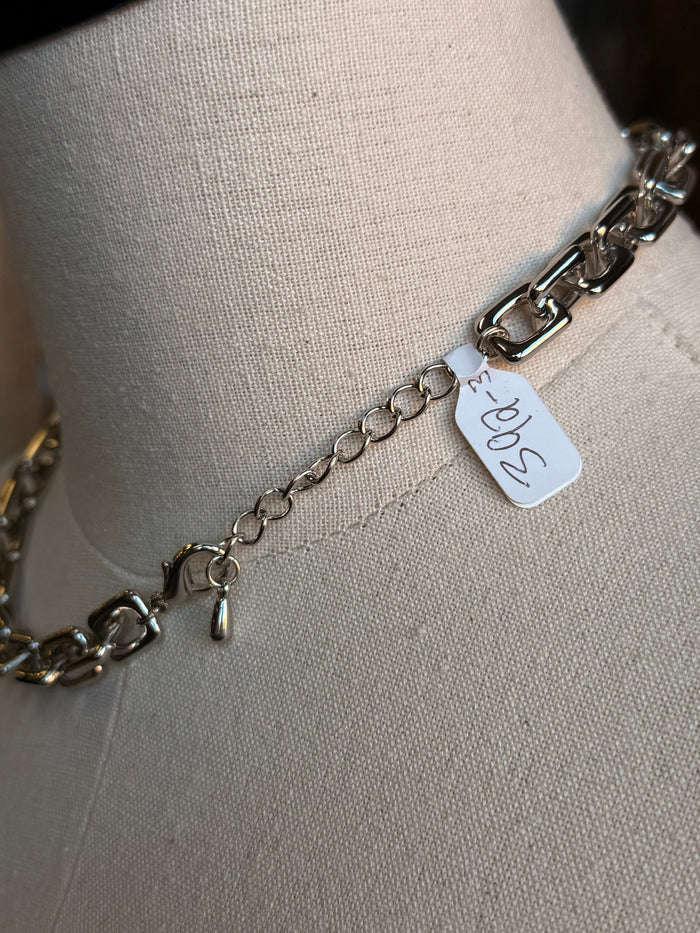 Silver chain necklace clasp with small metal tag