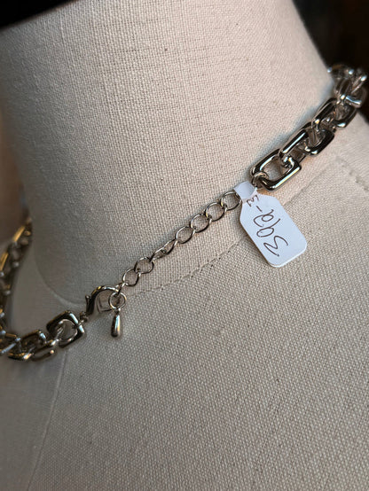 Silver chain necklace clasp with small metal tag