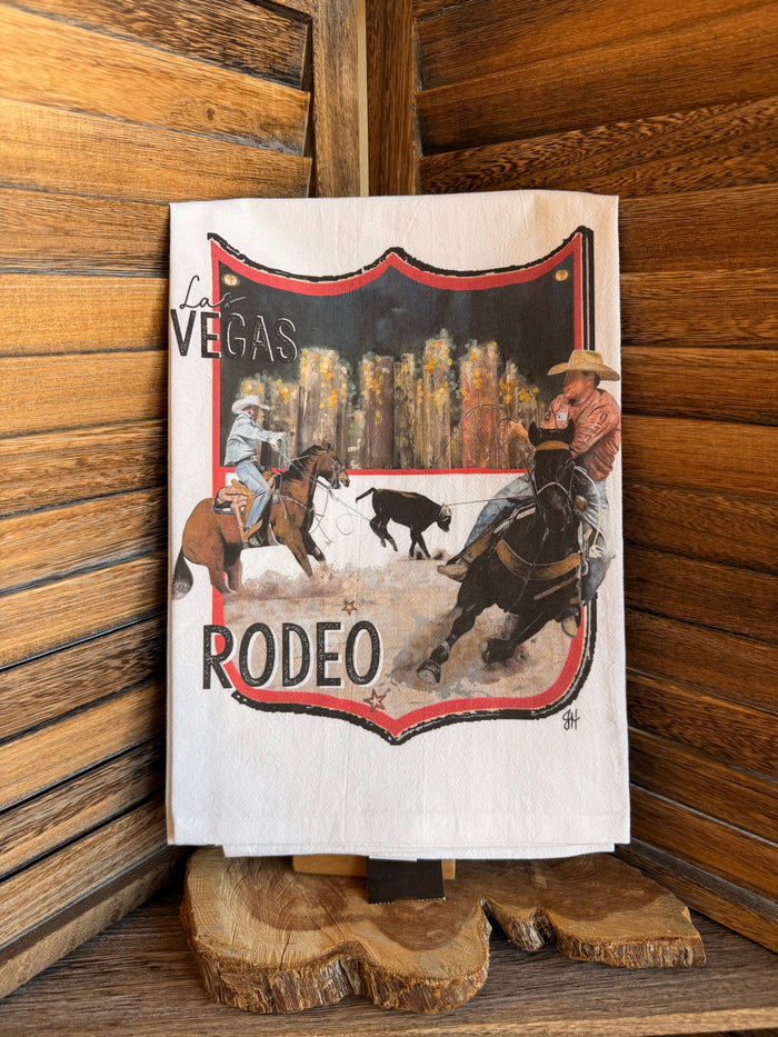 Rodeo watercolor tea towel with Las Vegas and rodeo text and cowboys riding horses