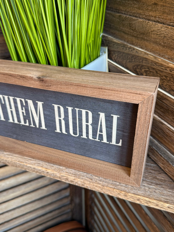 Close-up framed 12x4 artwork: 'RAISE THEM RURAL' lettering on dark panel