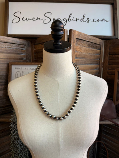 Silver pearl bead necklace on a mannequin bust
