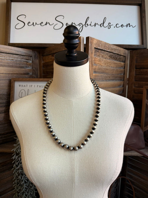 Silver pearl bead necklace on a mannequin bust