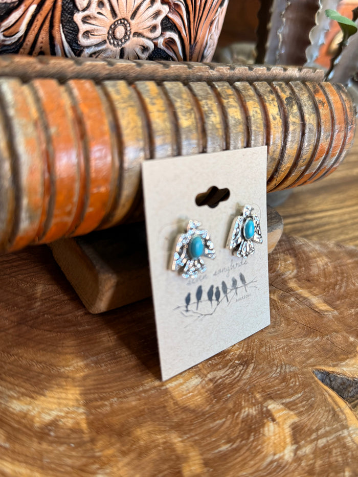 Turquoise thunderbird stud earrings with silver-tone textured frames