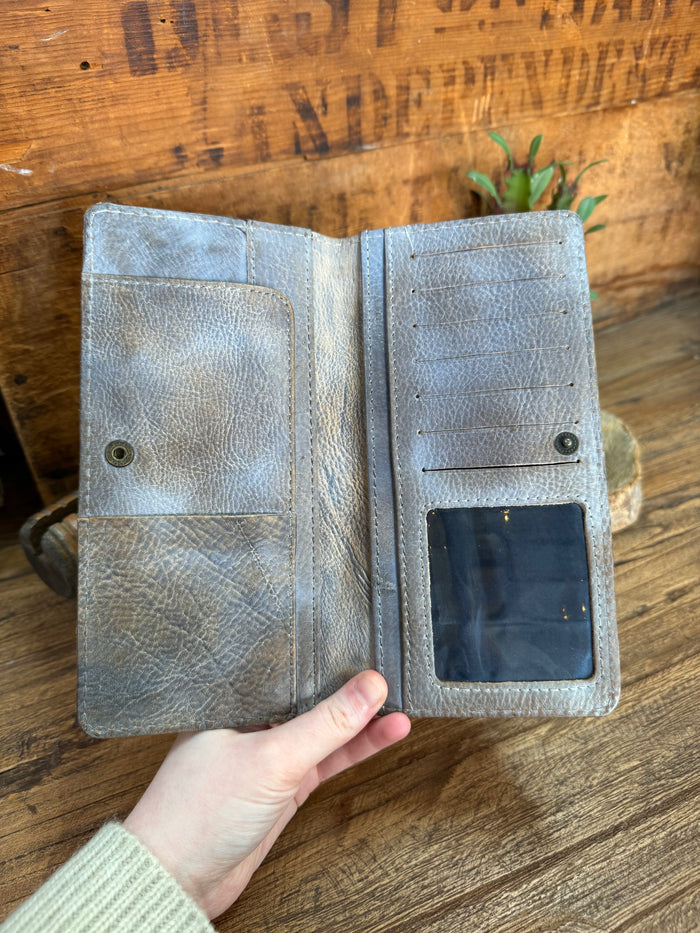 Gray cowhide checkbook wallet open, inside card slot and snap button closure