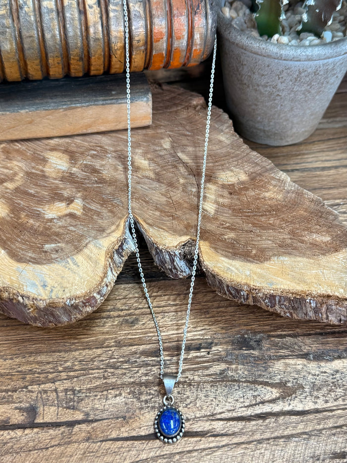 Layered silver chain necklace with oval lapis blue pendant