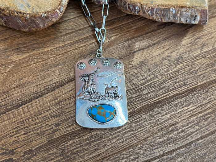 Rectangular turquoise pendant with western horses scene and globe emblem on silver chain