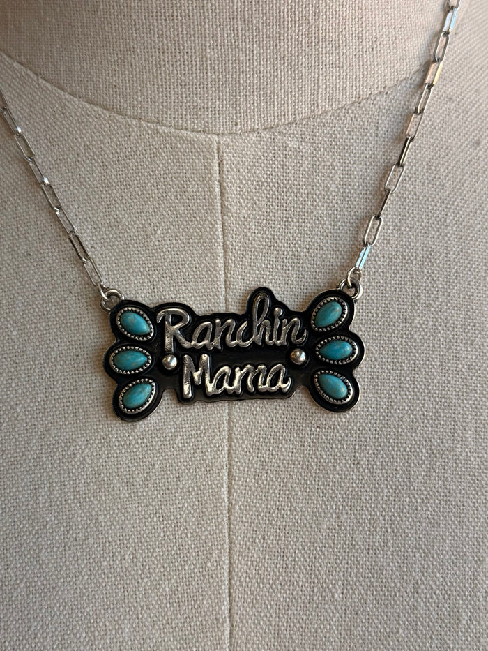 Close-up: turquoise “Ranchin’ Mama” pendant with outlined floral edges