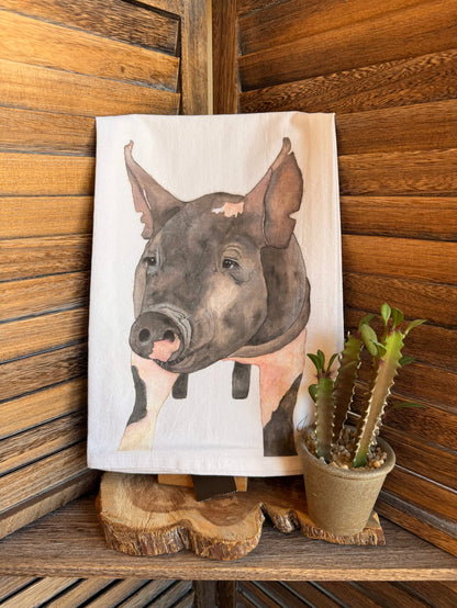 Pig watercolor tea towel with folded white fabric and large gray pig illustration