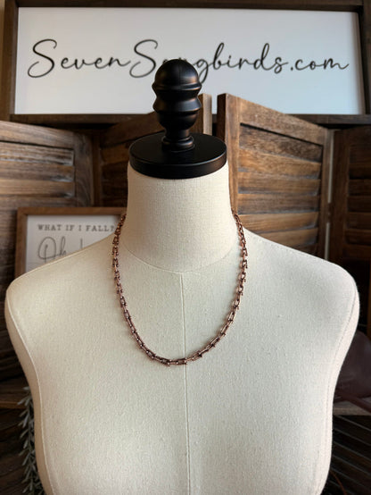 Triple pearl stack necklace with copper-tone beaded chain, three-row layered design